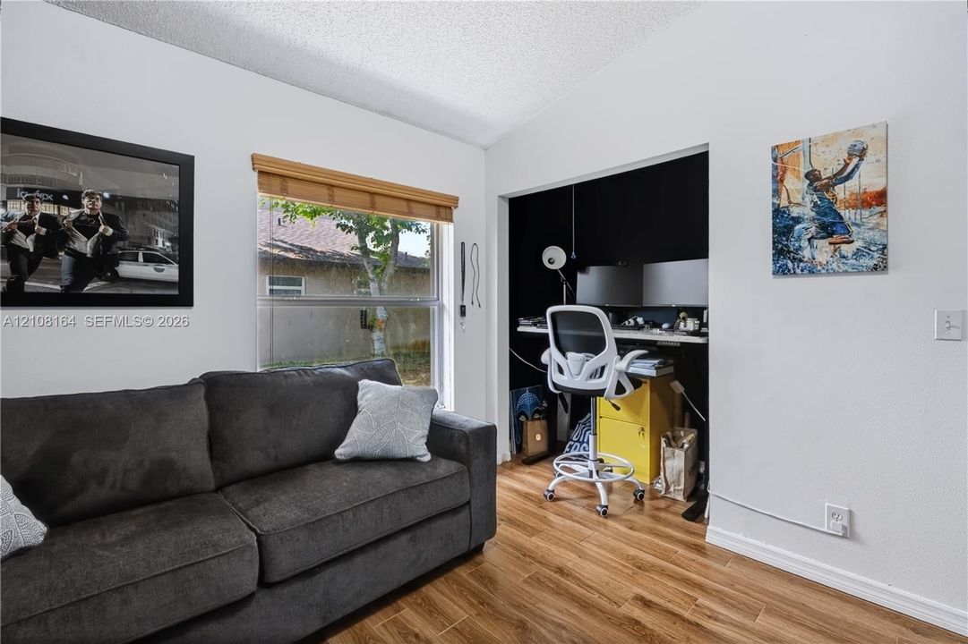 Wood-finish flooring, recessed alcove, and window with natural light
