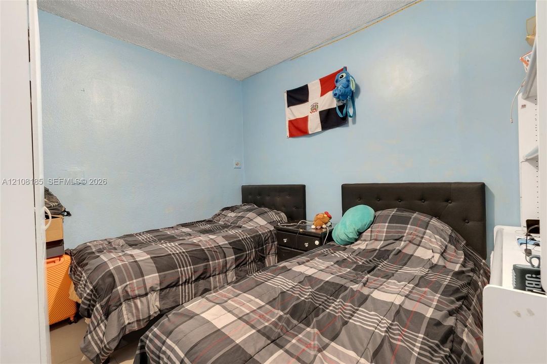 Bedroom featuring a smooth-texture ceiling and light blue wall finish