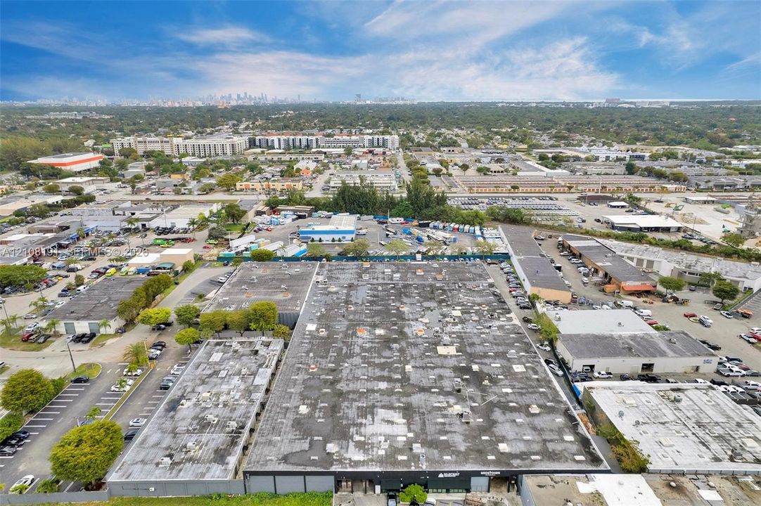 Large-scale industrial complex featuring a multi-unit warehouse structure, flat roofing systems, and dedicated asphalt parking areas