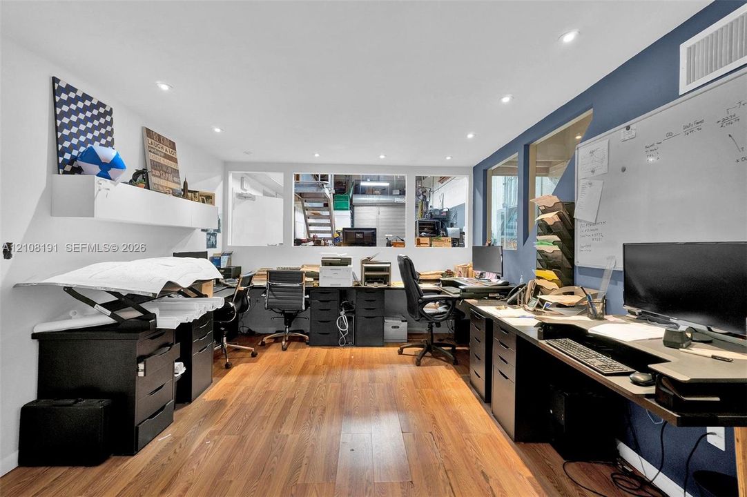 Wood-finish flooring, recessed lighting, and interior glass partitions