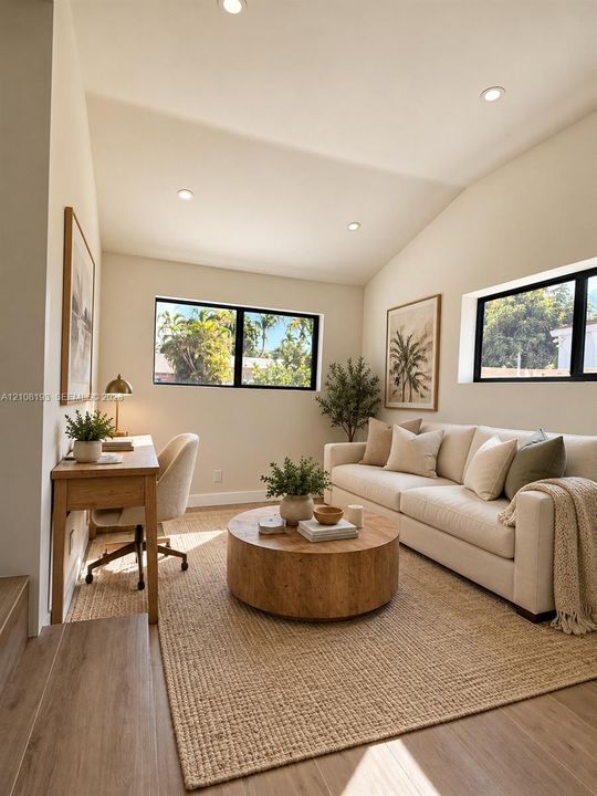 Vaulted ceilings, wood-finish flooring, and black-framed windows