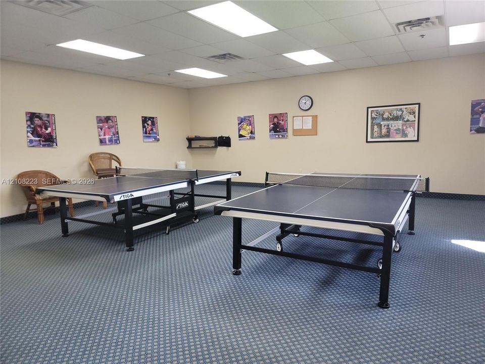 Spacious room featuring a drop ceiling with recessed lighting and wall-to-wall carpeting