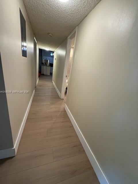 Hallway featuring wood-finish flooring and recessed lighting