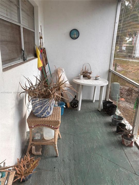 Screened-in porch featuring painted concrete flooring and aluminum-framed screening