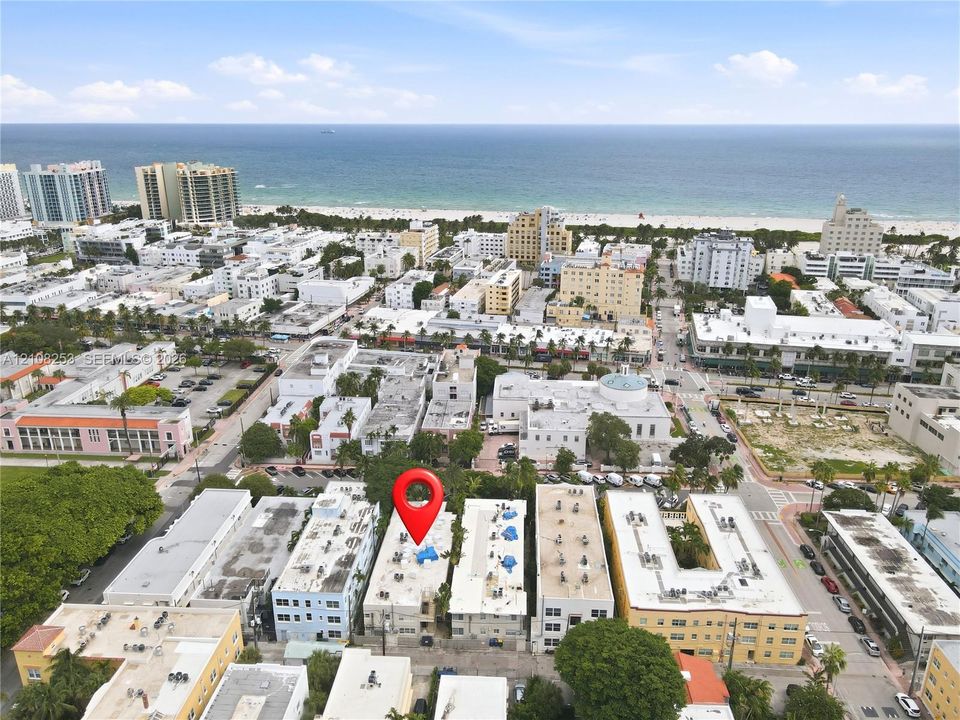 Aerial perspective featuring a multi-story urban building situated in a coastal metropolitan setting