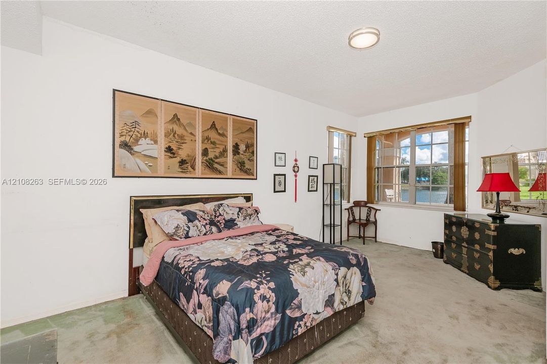 Room featuring multi-pane windows and a flush-mount ceiling light fixture