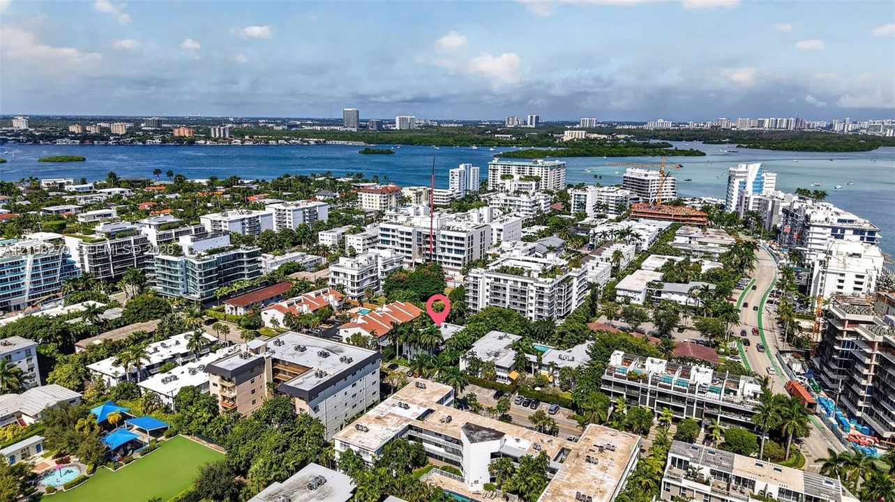Aerial perspective of the property location, characterized by mature tropical landscaping, dense residential density, and proximity to coastal waters