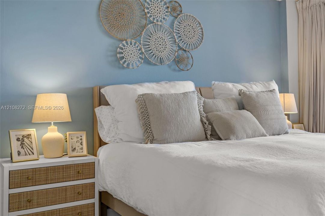 Room featuring neutral wall tones and floor-to-ceiling window treatments