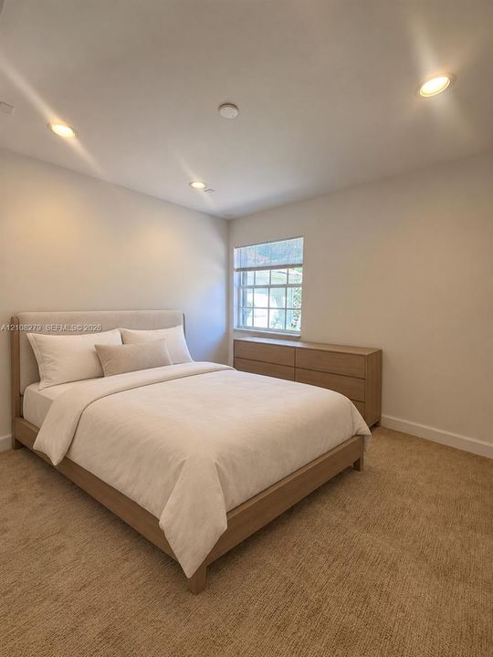 Neutral-toned interior featuring recessed lighting, wall-to-wall carpeting, and a multi-pane window