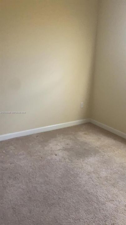 Interior room featuring wall-to-wall carpeting and neutral-toned painted walls