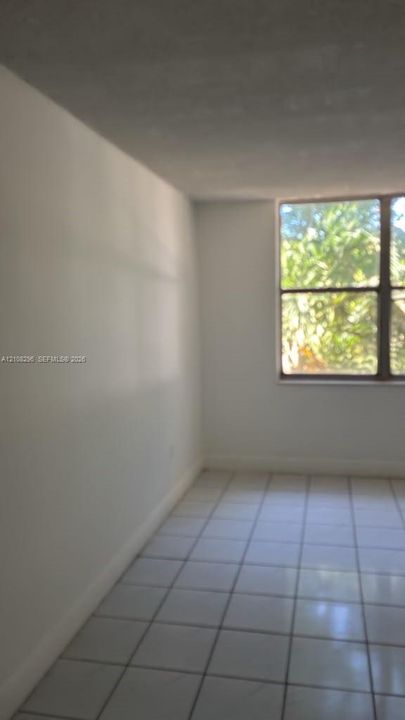 Interior space featuring large-format tile flooring and a multi-pane window