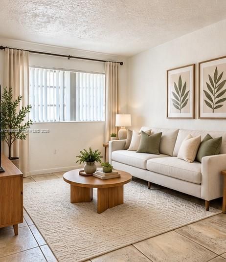 Neutral-toned tile flooring, large-scale window with vertical blinds, and textured wall finish