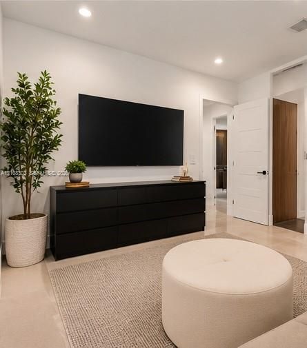 Recessed lighting, smooth-finish neutral walls, polished tile flooring, and solid-core interior doors with matte black hardware