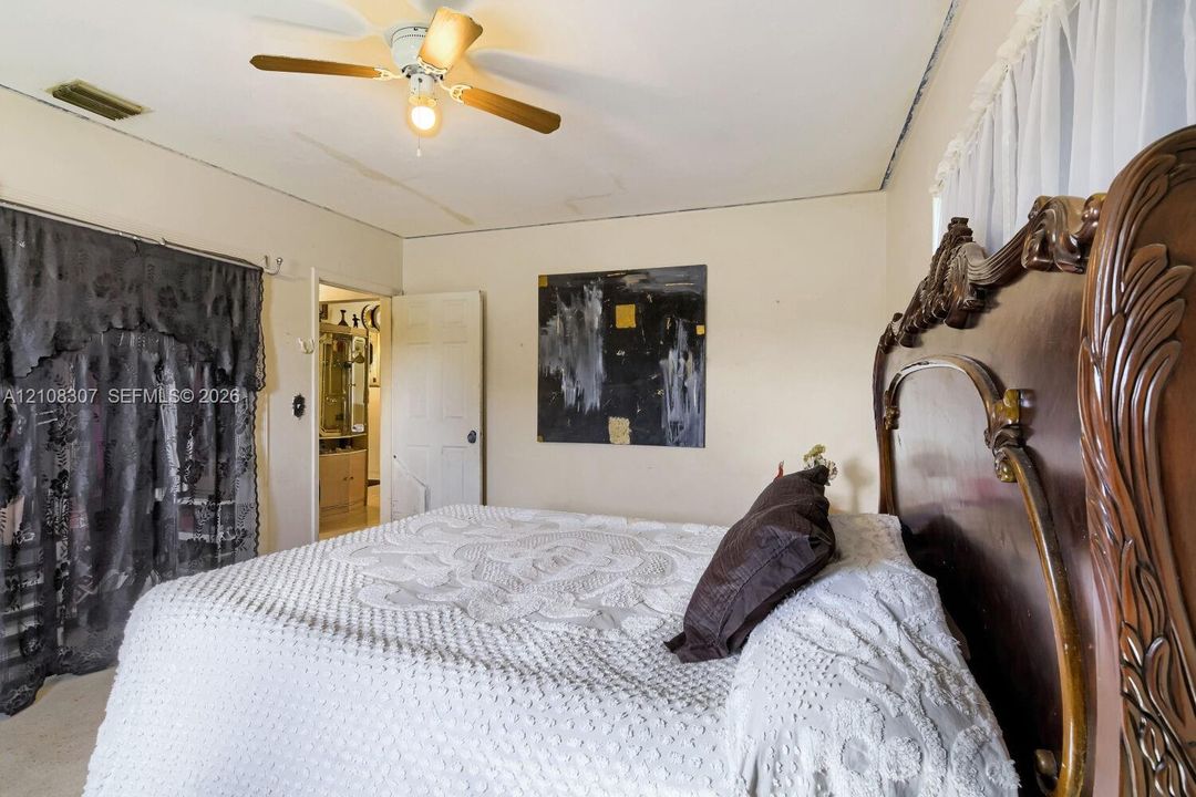Room featuring a ceiling fan with integrated light fixture and a neutral color palette