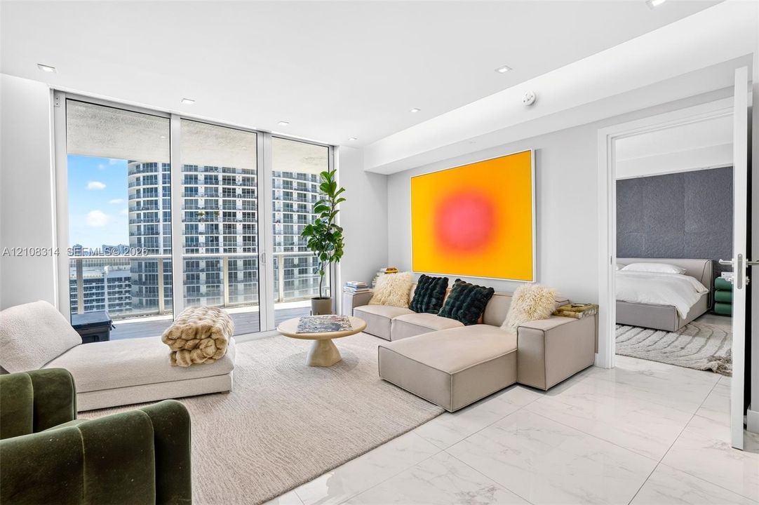 Floor-to-ceiling windows, polished stone-finish tile flooring, and recessed ceiling lighting