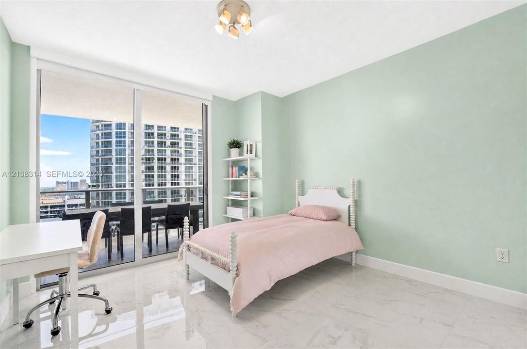 Floor-to-ceiling sliding glass doors, polished stone-finish flooring, and built-in shelving