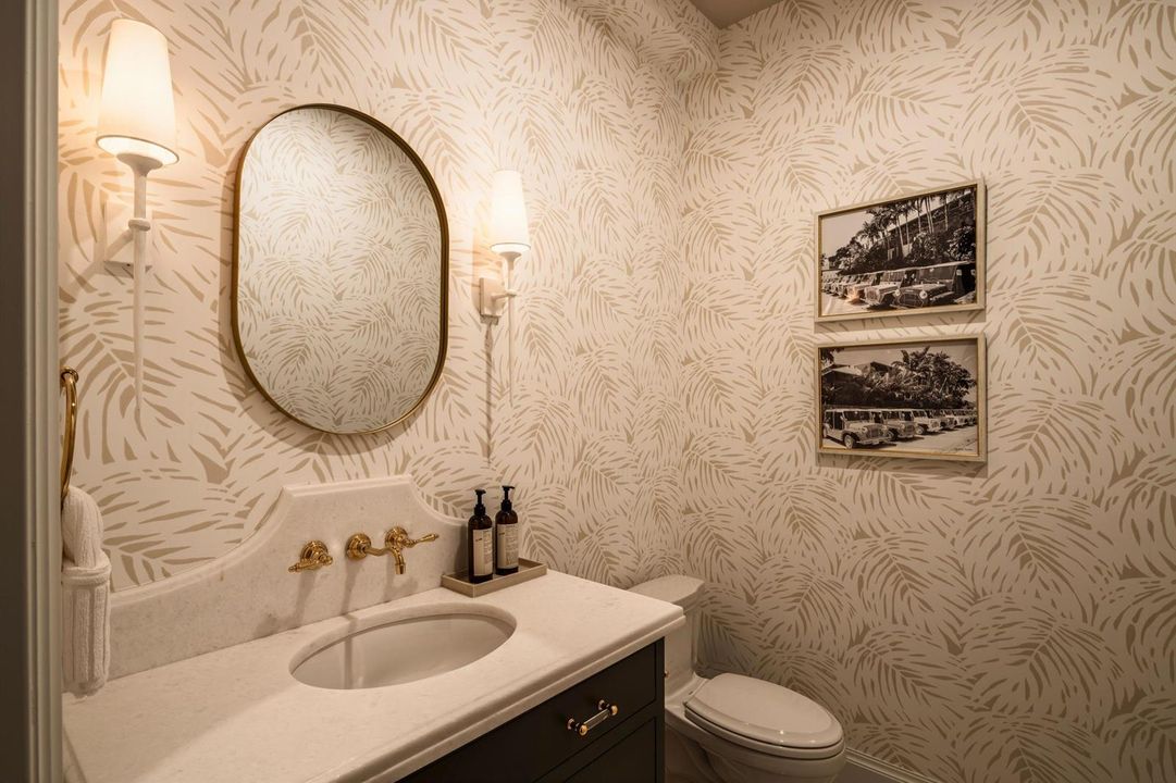 26 - Powder room with cream palm wallpap