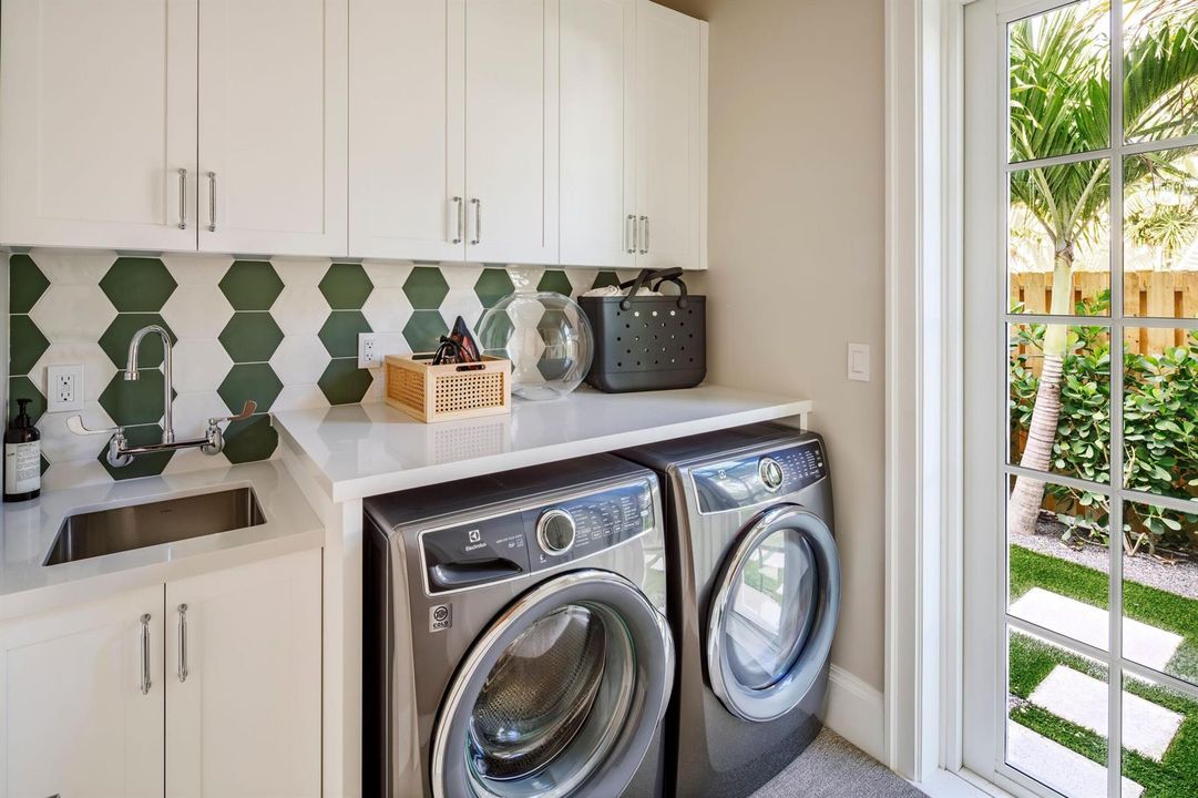 40 - Laundry room with white cabinets, g