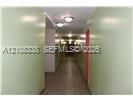Interior corridor featuring tile flooring and flush-mount ceiling lighting