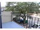 Balcony featuring a solid privacy wall and a black metal railing