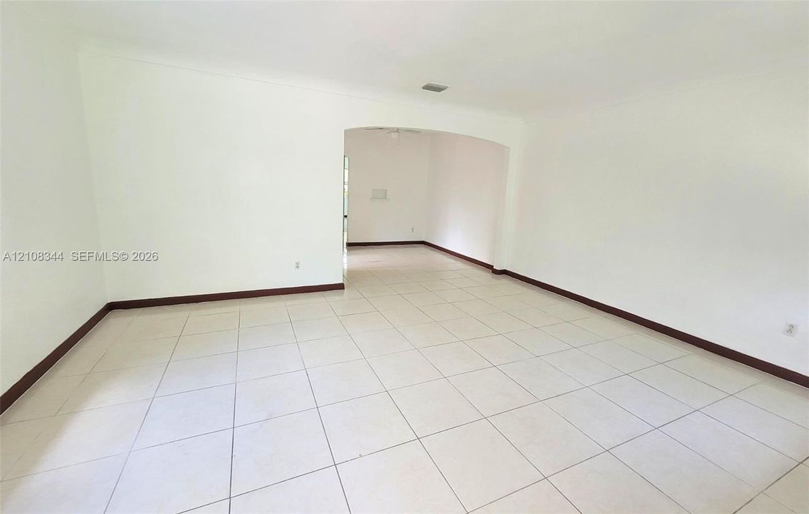 Additional view of the spacious living area with easy-care tile flooring.