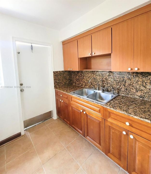 Kitchen cabinetry provides convenient storage and ample countertop workspace.