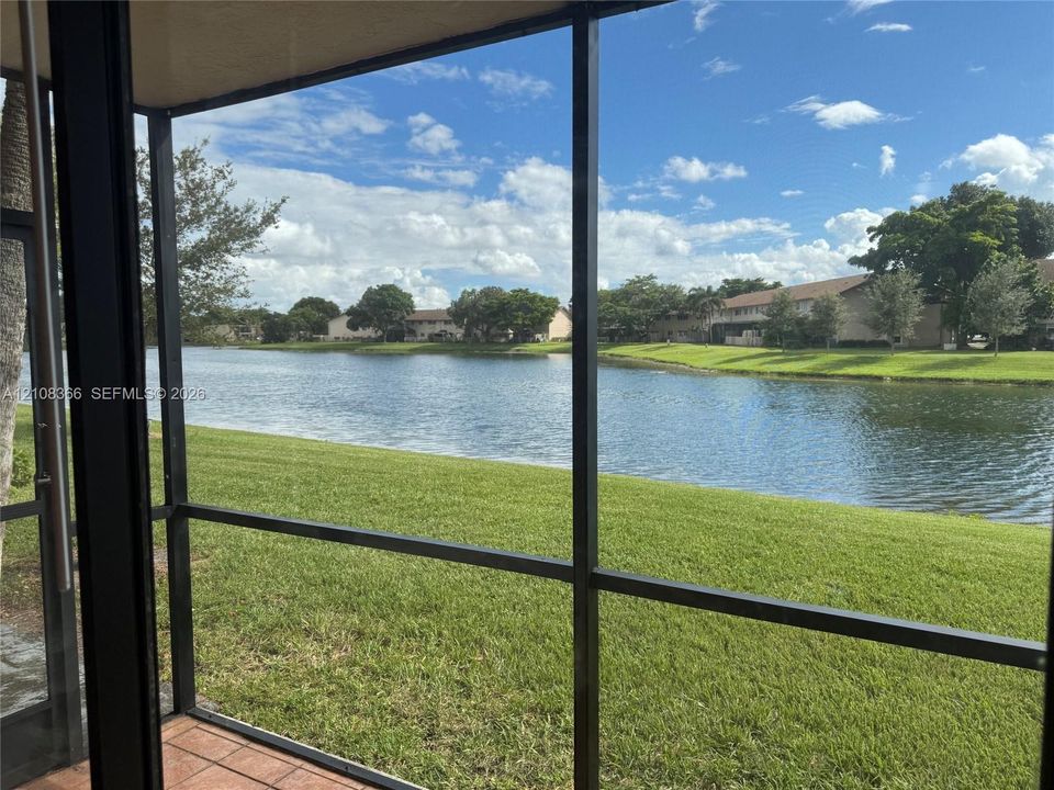 Screened-in enclosure featuring tile flooring and water frontage