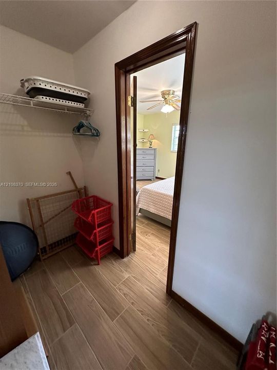 Storage closet featuring wood-finish tile flooring and wire shelving