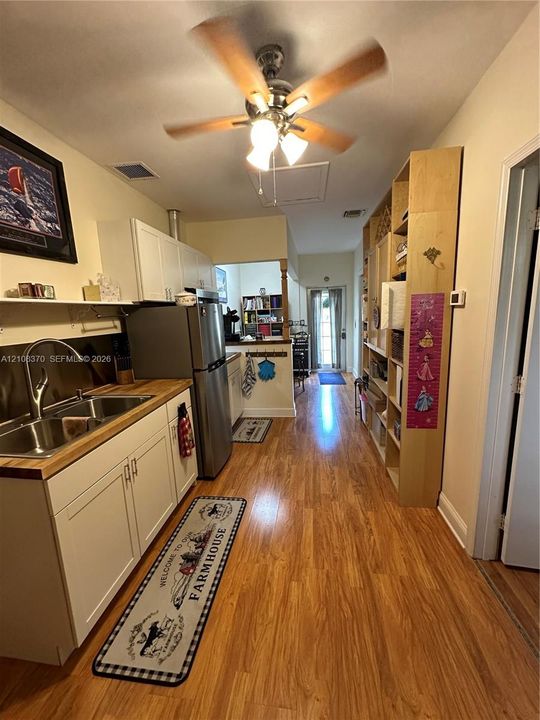 Room featuring wood-finish flooring and a horizontal window with slatted blinds