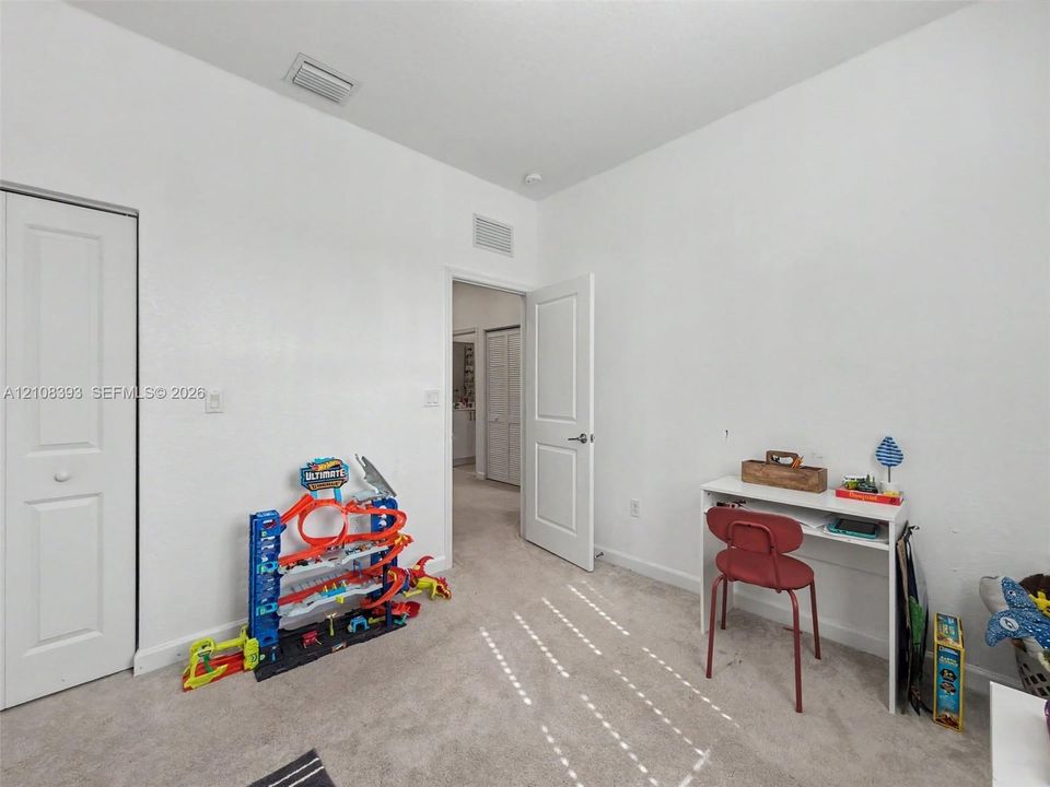Interior space featuring neutral-toned carpeting, two-panel interior doors, and a closet with a bi-fold door