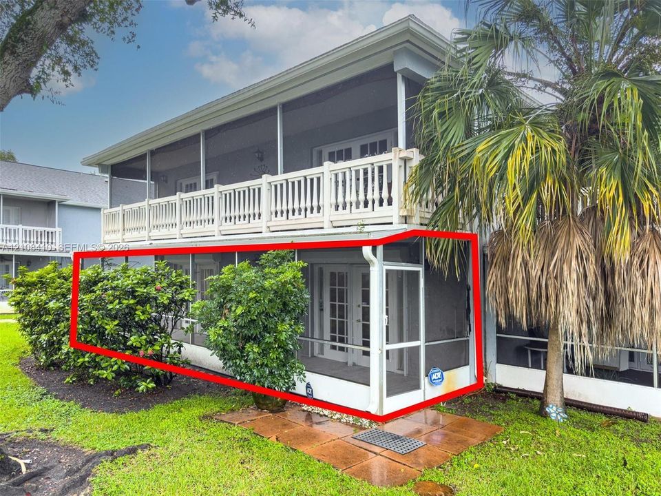 Ground-level screened-in porch featuring aluminum framing and multi-panel glass entry doors