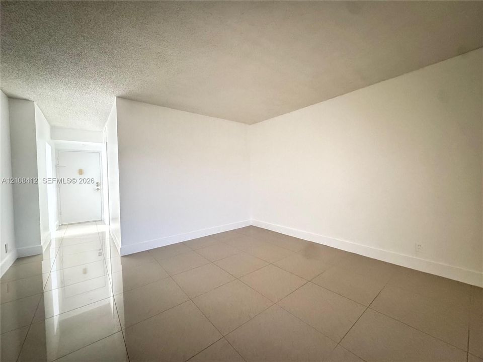 Neutral-toned large-format tile flooring and white interior wall finishes