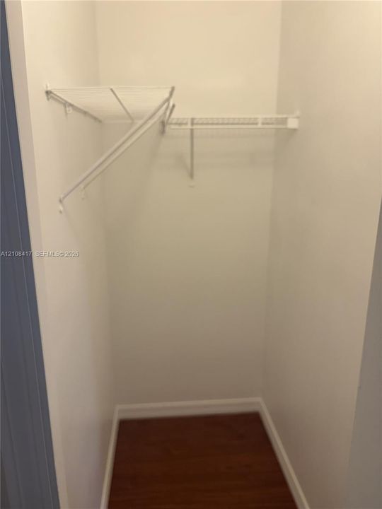 Closet interior featuring wood-finish flooring and white wire shelving
