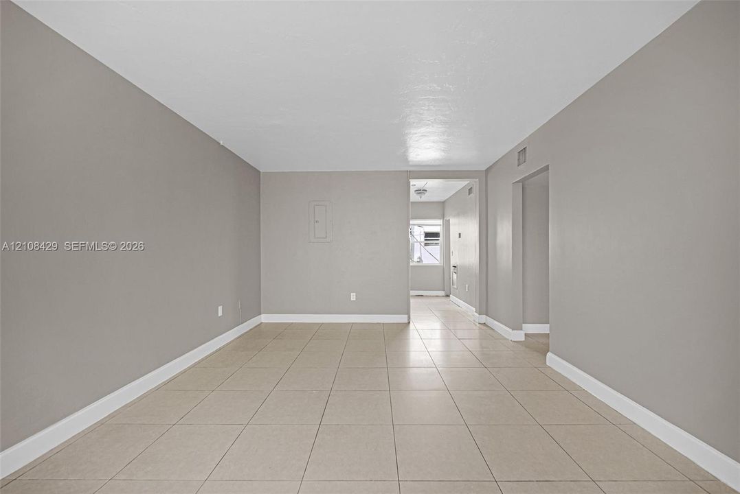 Interior space featuring neutral-toned wall paint and oversized tile flooring