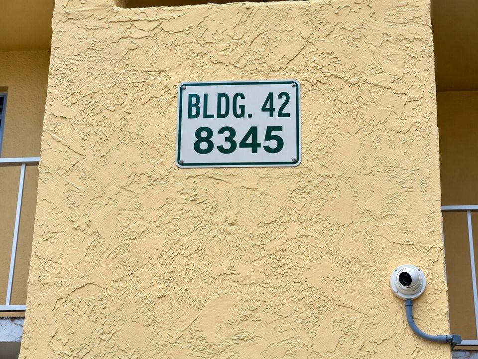 Building 42 Stucco Sign and Camera