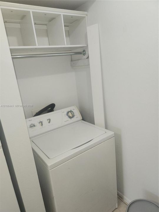 Built-in overhead shelving with an integrated metal clothing rod