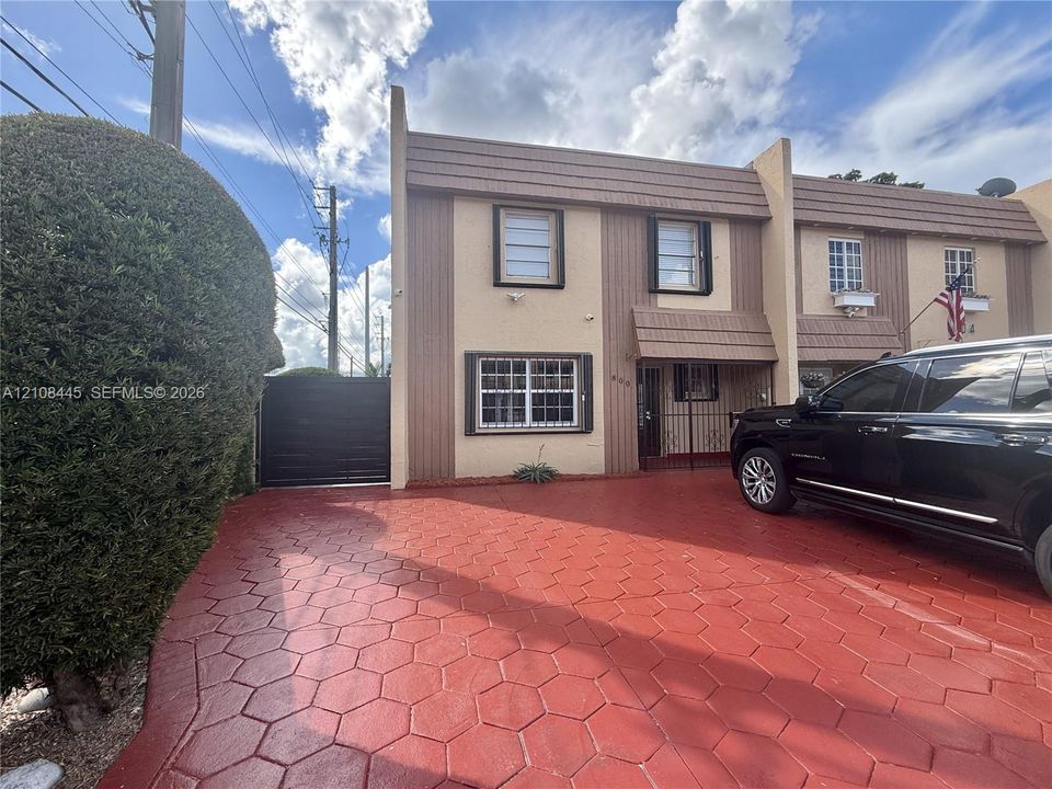 Two-story residence with privacy gate