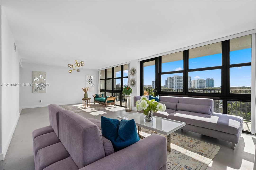 Floor-to-ceiling windows, polished concrete flooring, multi-arm flush-mount lighting, and integrated exterior balcony access