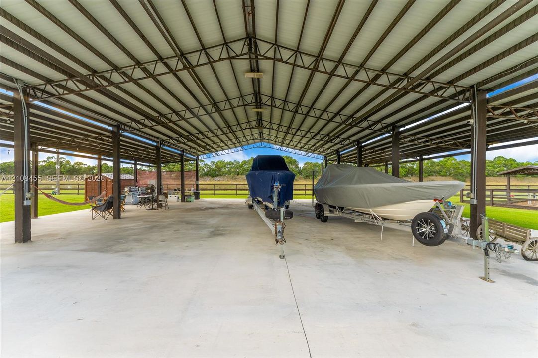 Expansive covered storage structure featuring a steel frame, high-clearance roof, and concrete slab flooring