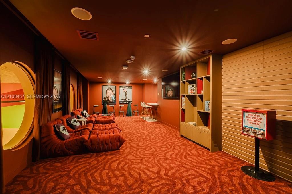Custom built-in shelving, circular architectural wall cutouts, recessed ceiling lighting, and a built-in counter area