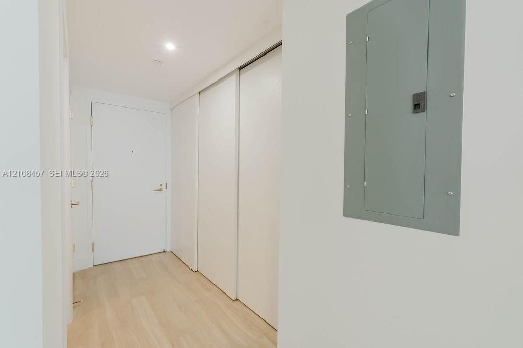 Wood-finish flooring, full-height sliding-door closet, and solid core entry door