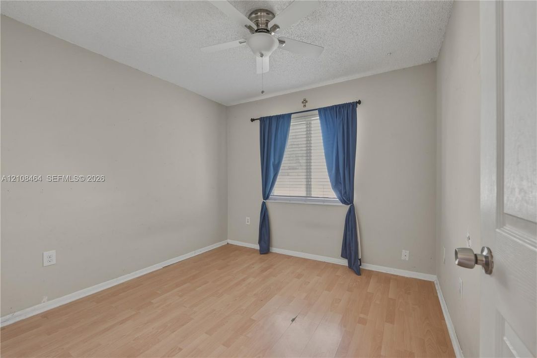 Wood-finish flooring, central ceiling fan, and horizontal window blinds