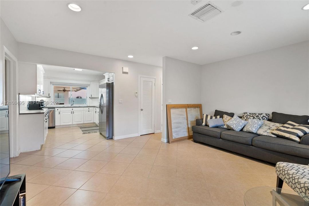 Open-concept area featuring neutral wall tones, recessed lighting, and tile flooring throughout