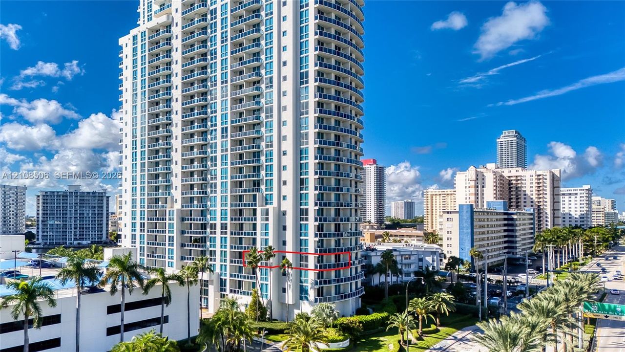 High-rise residential tower featuring a glass facade, private balconies, and concrete construction