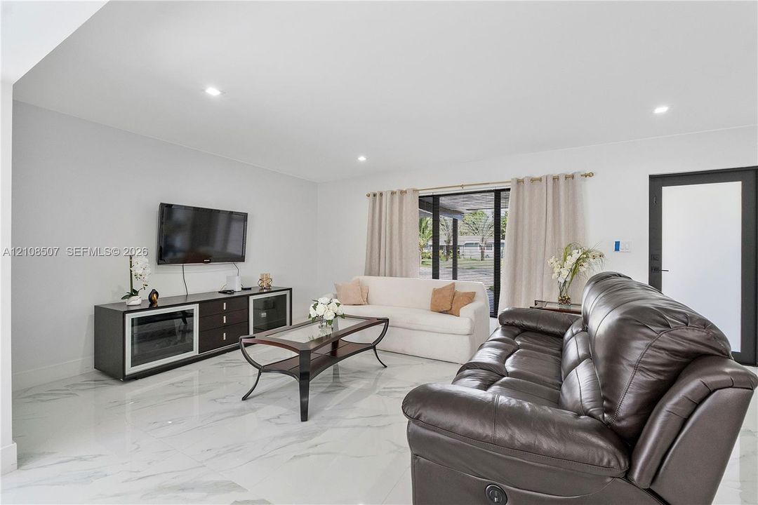 Polished stone-look flooring, recessed lighting, and expansive glass sliding doors