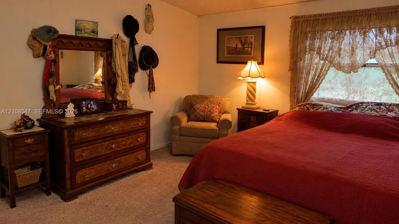 Bedroom featuring wall-to-wall carpeting and a window with natural light
