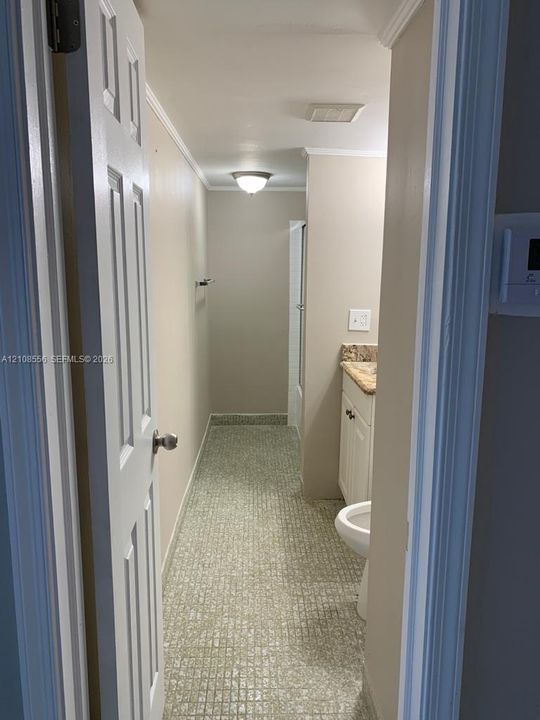 Bathroom featuring tiled flooring, stone-finish countertop, white cabinetry, and flush-mount ceiling lighting