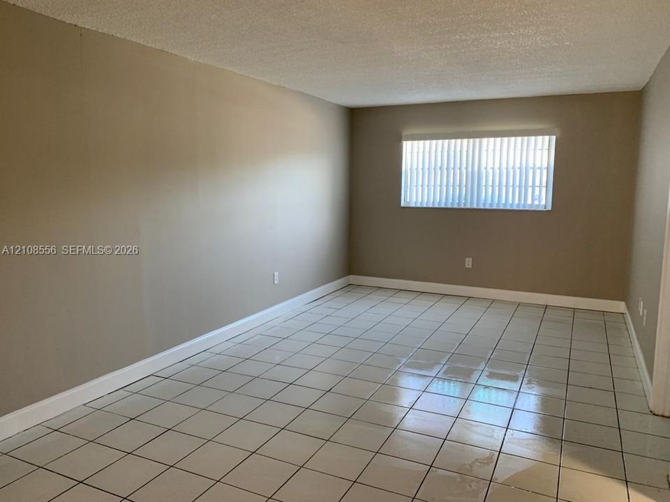 Interior space featuring light-toned tile flooring and neutral wall paint