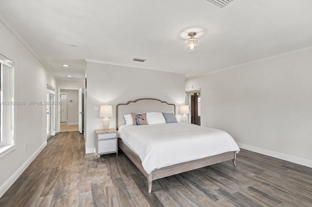 Neutral-toned room featuring wood-finish flooring, recessed lighting, and a flush-mount overhead fixture