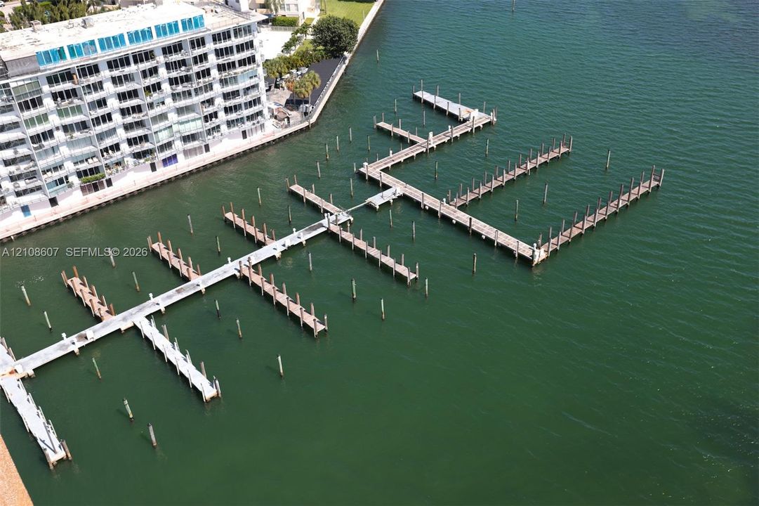 Private marina featuring multiple deep-water boat slips, finger piers, and reinforced pilings